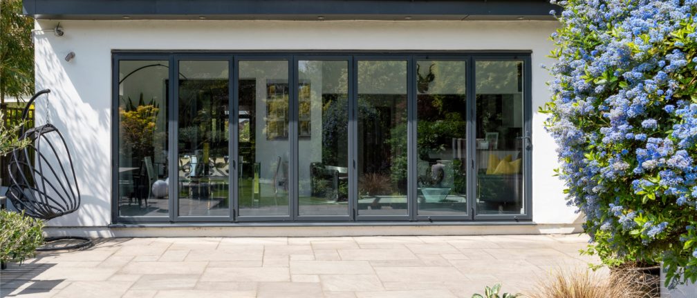 Stylish,,Closed,,Bifold,Doors,With,Plants,In,Spring,,Summer,,Revealing