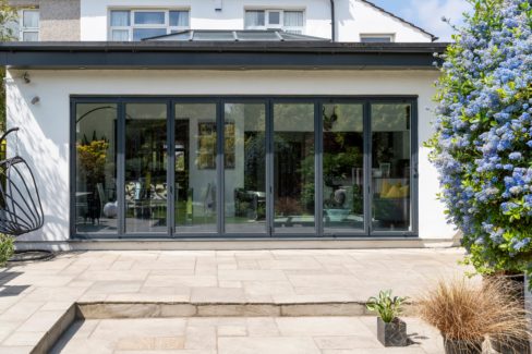 Stylish,,Closed,,Bifold,Doors,With,Plants,In,Spring,,Summer,,Revealing